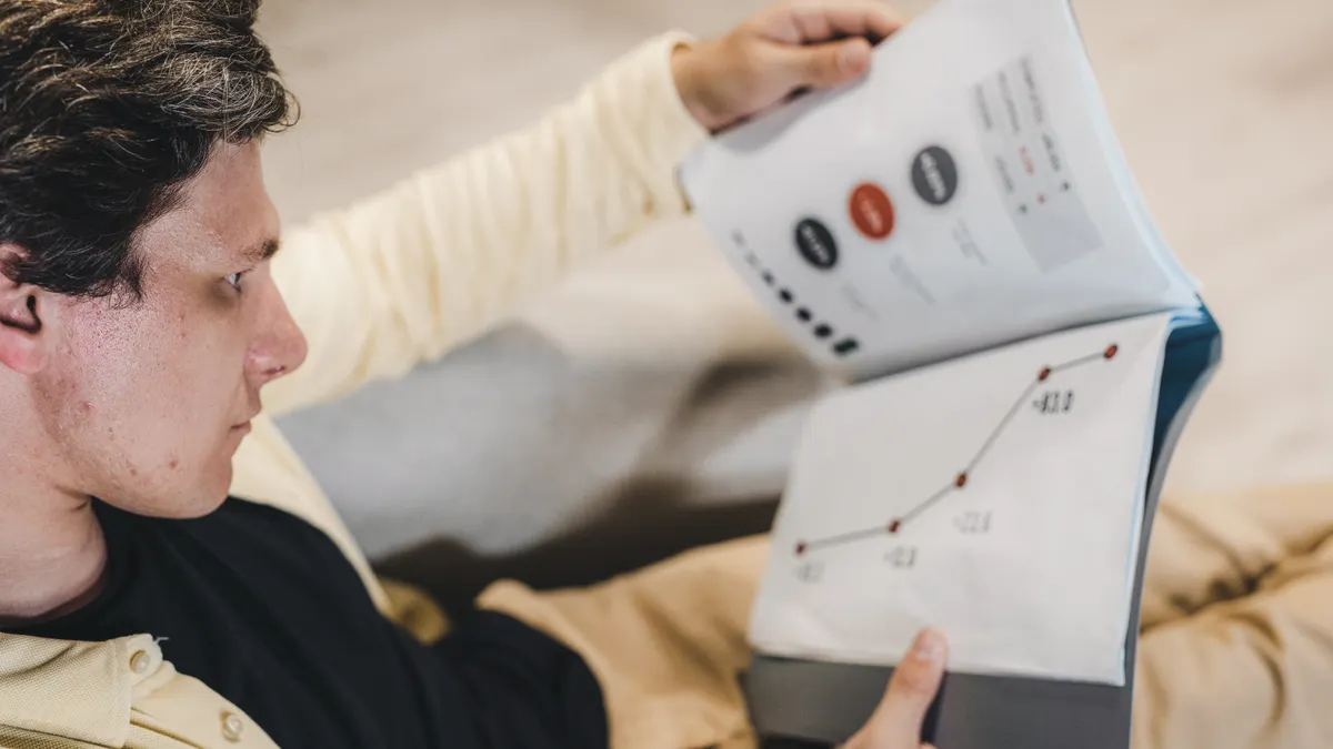 How to Read a Home Water Test Report Person reading a report with graphs and numbers