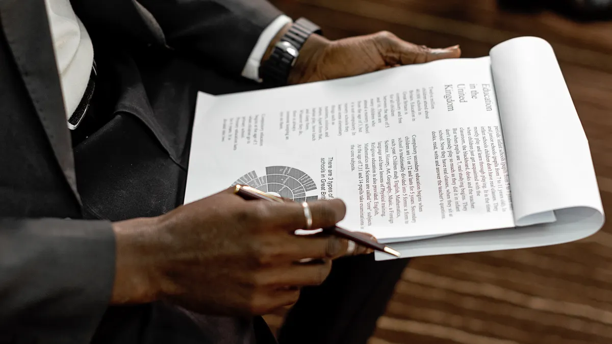 Man reviewing a report with charts and text